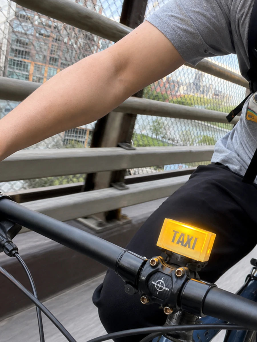 Taxi Bike Buddy mounted on a flat-bar bicycle while riding in the city