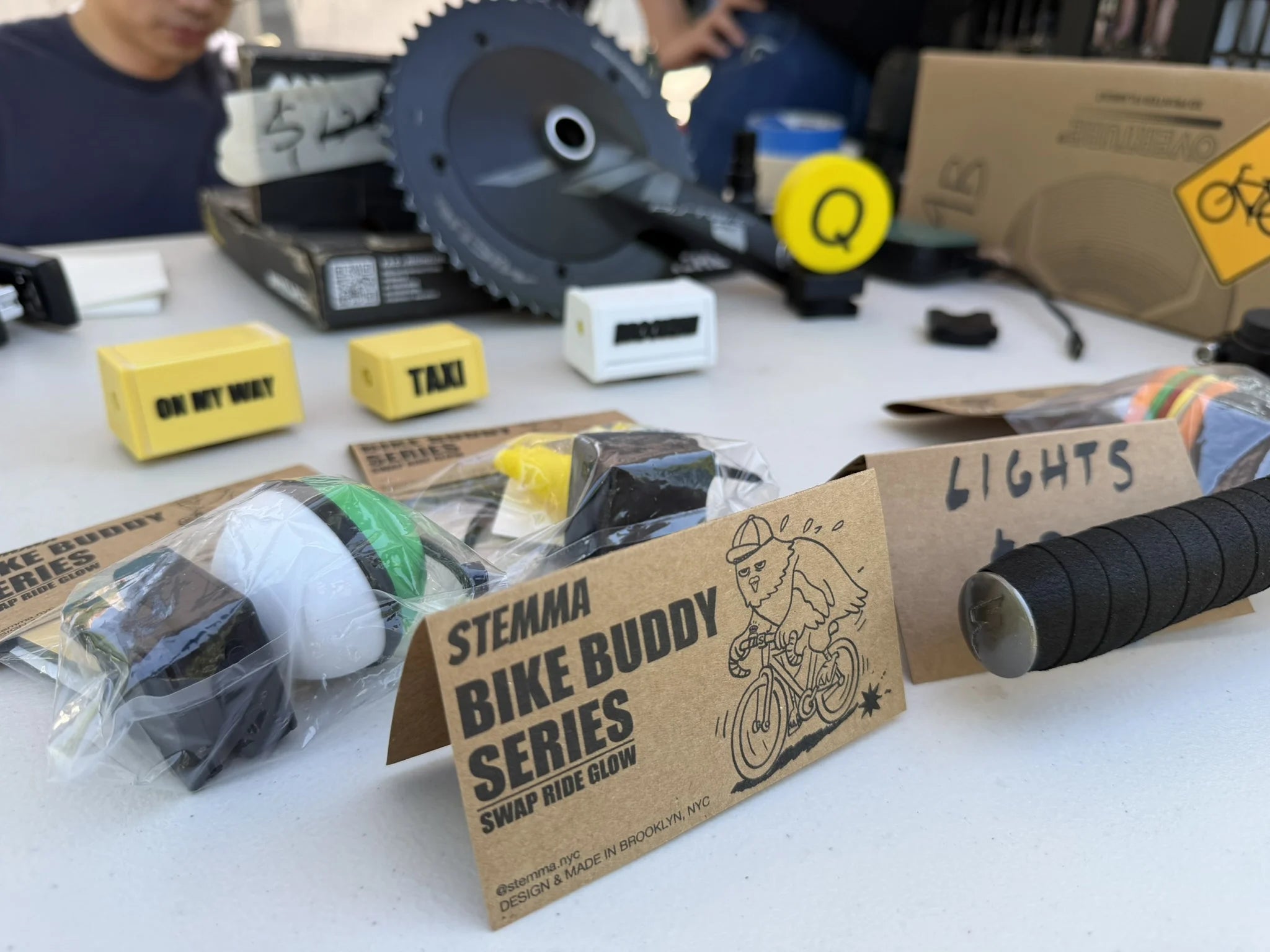 Bike Buddy products and packaging displayed at an outdoor market